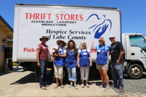 employees and volunteers in front of the hospice services delivery truck
