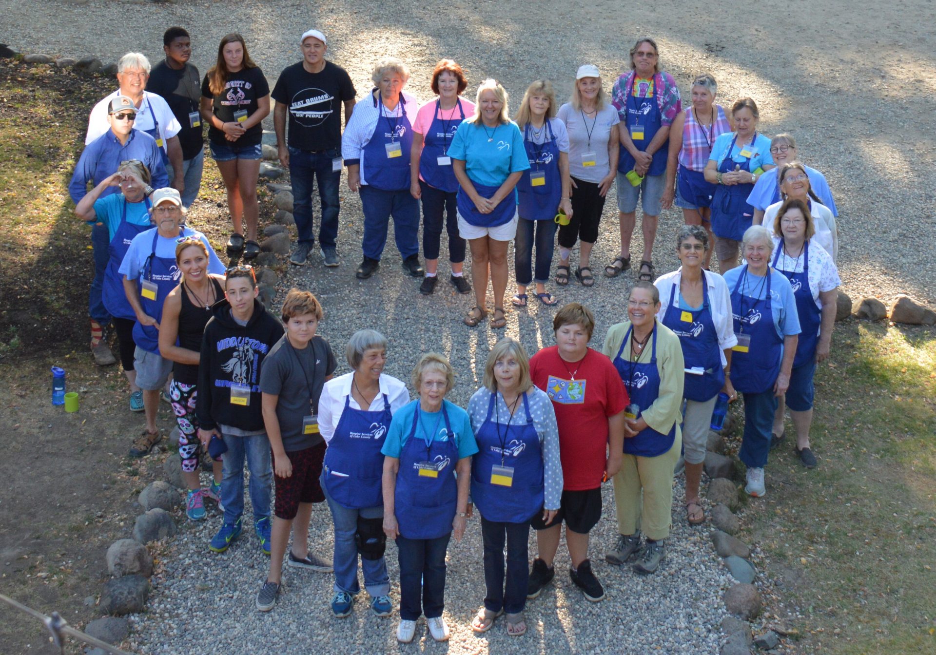 Group of volunteers from Wings of Hope camp standing in a heart shape